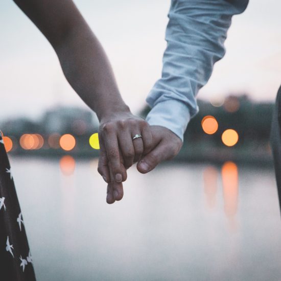 Couple holding hands on their way out for a date