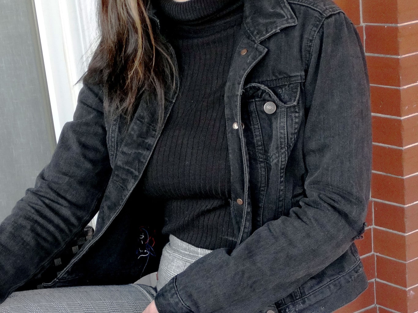 This grunge grey denim jacket accents Mackenzie's black turtleneck sweater.