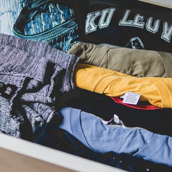 Drawer filled with folded t-shirts