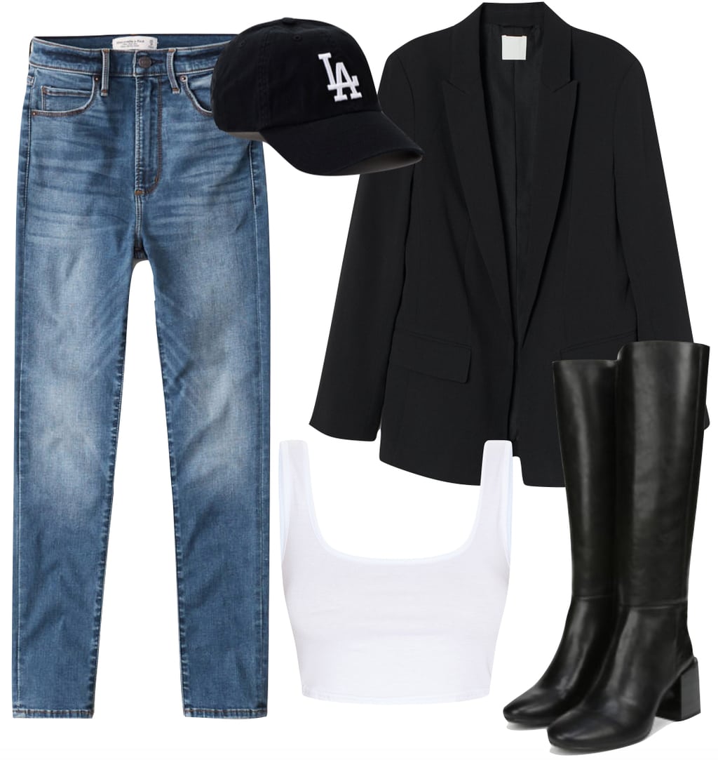Jordyn Woods Outfit #3: skinny jeans, black blazer, L.A. Dodgers baseball cap, white crop top, and black faux leather knee-high boots
