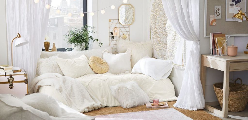 Cream dorm room with gold accents from pb teen