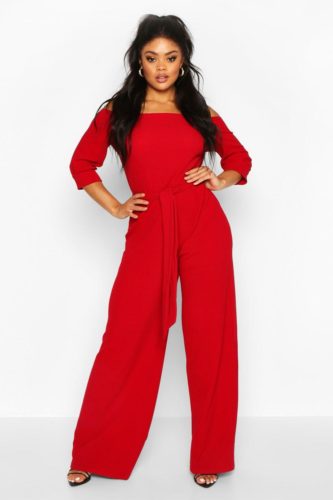 A off the shoulder tailored red jumpsuit and black heels.