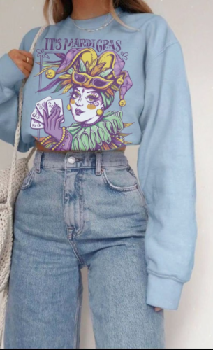 Pastel blue Mardi Gras sweatshirt paired with high waisted jeans