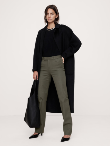 Dark academia outfit for winter with green flare pants, black top, black overcoat