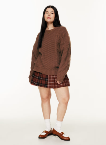 Dark academia skirt outfit with chunky brown cable-knit sweater and brown and red plaid mini skirt